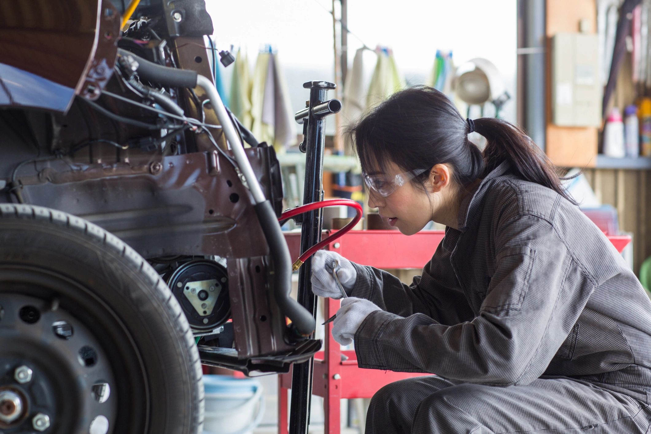 auto mechanic working on Japanese car